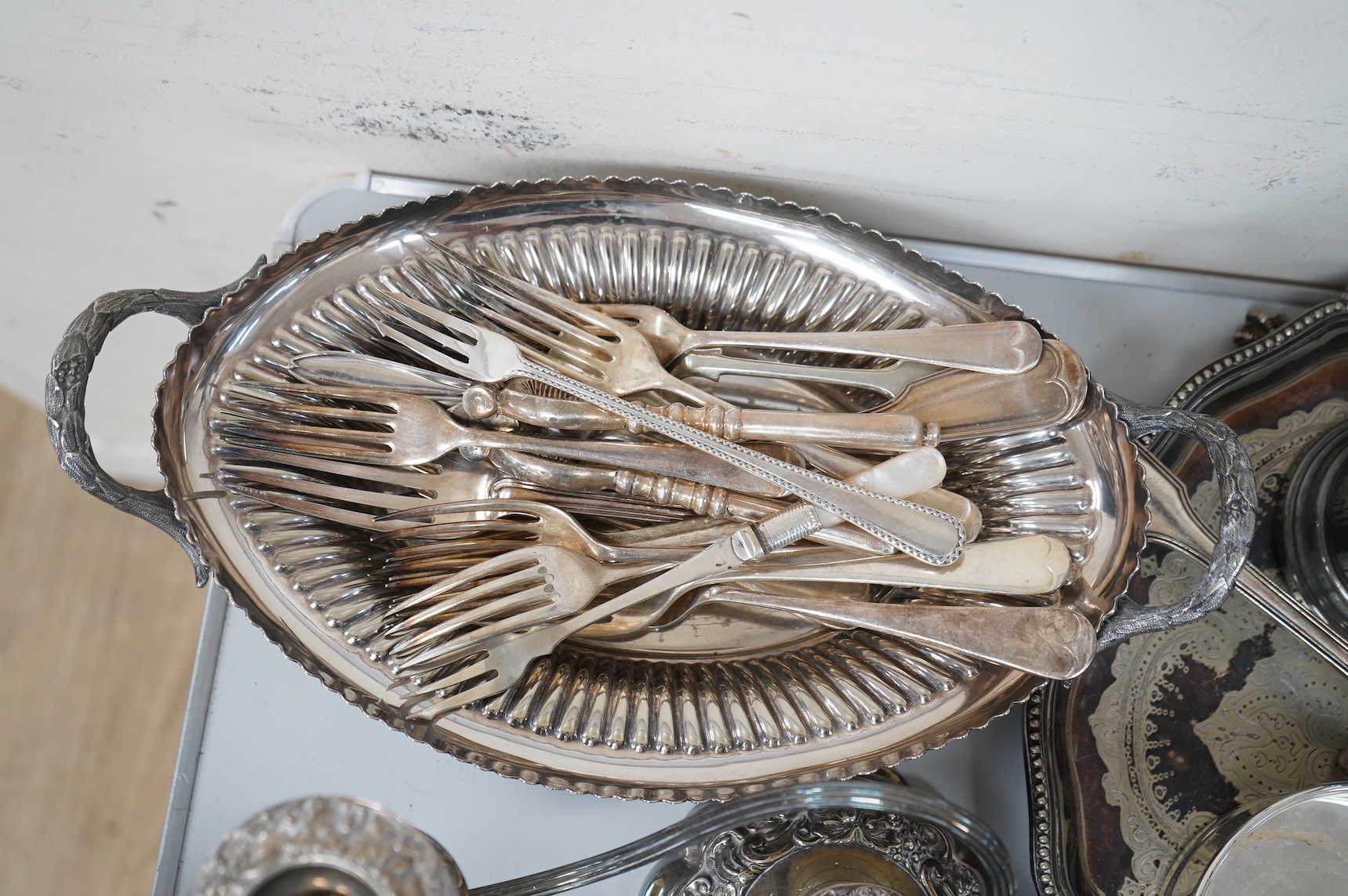A collection of silver plate to include cased dessert forks, a hammered tea pot, pair of candlesticks and a salver